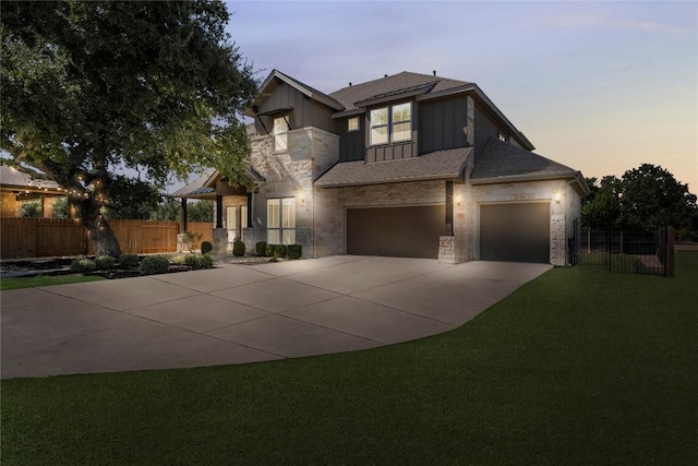 110 Magona Trl, Georgetown, TX 78628 - view of front facade with fence, stone siding, board and batten siding, a lawn, and driveway