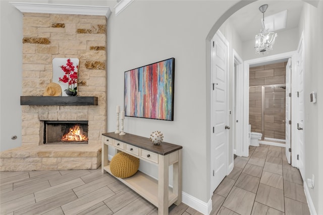 corridor featuring an inviting chandelier and ornamental molding