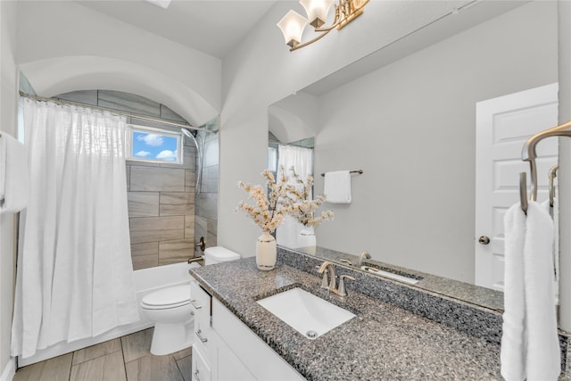 full bathroom with toilet, vanity, and shower / tub combo