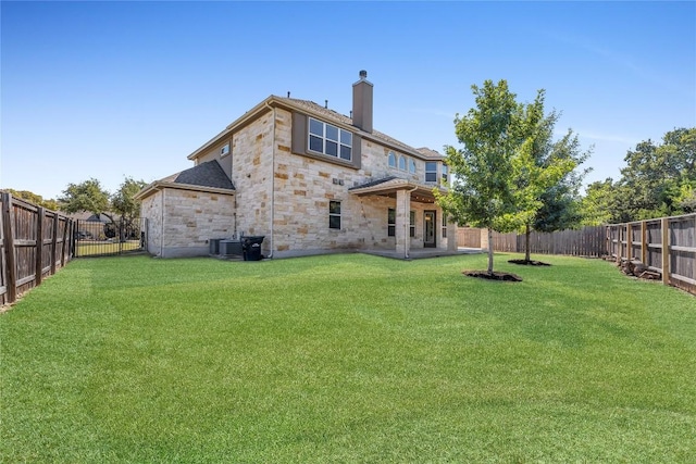 110 Magona Trl, Georgetown, TX 78628 - back of house with stone siding, cooling unit, a fenced backyard, a chimney, and a lawn