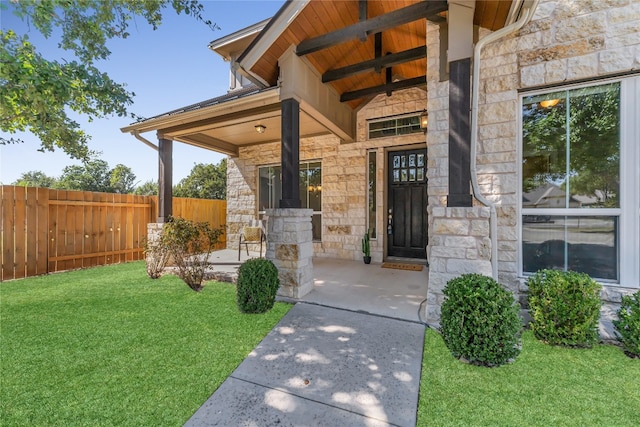 property entrance with a lawn