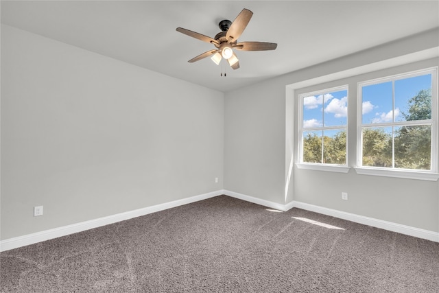 carpeted spare room featuring ceiling fan