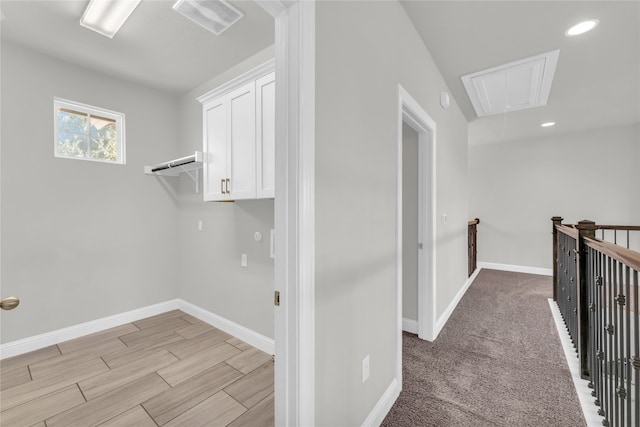 clothes washing area featuring light colored carpet