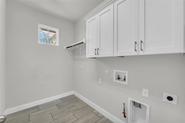 clothes washing area with hookup for a gas dryer, hookup for an electric dryer, cabinets, and hookup for a washing machine