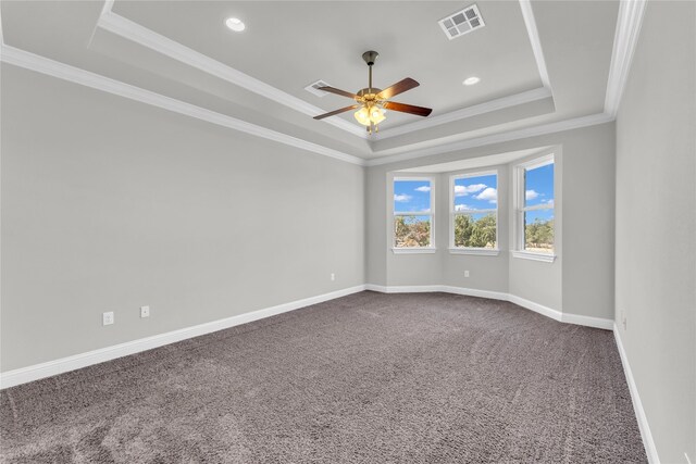 carpeted empty room with crown molding, a tray ceiling, and ceiling fan