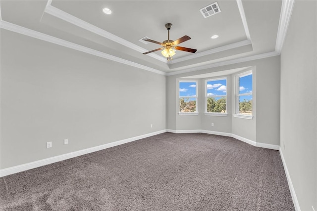 110 Magona Trl, Georgetown, TX 78628 - empty room featuring a raised ceiling, dark carpet, baseboards, visible vents, and ornamental molding