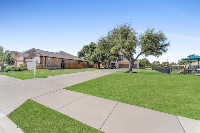110 Magona Trl, Georgetown, TX 78628 - view of front of house with fence, a front lawn, driveway, and a garage