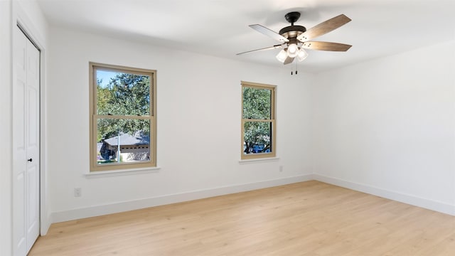 unfurnished room featuring ceiling fan, a wealth of natural light, and light hardwood / wood-style flooring