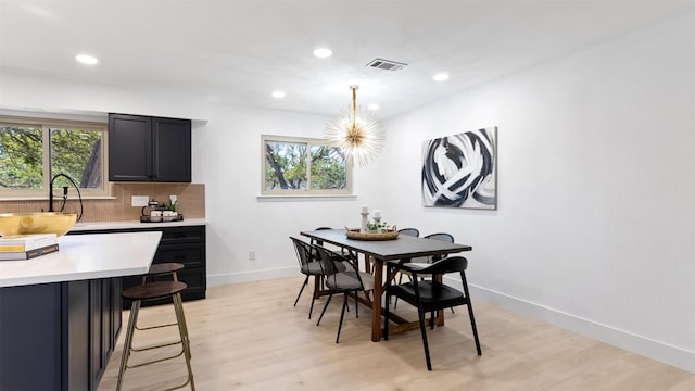 dining room featuring light wood-type flooring and sink