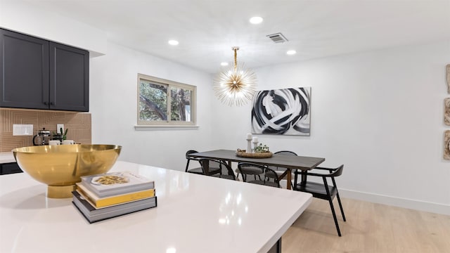 kitchen featuring an inviting chandelier, light hardwood / wood-style floors, and hanging light fixtures