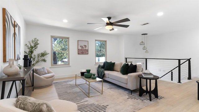 living room featuring ceiling fan and light hardwood / wood-style flooring