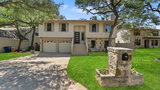 split foyer home featuring a front lawn and a garage