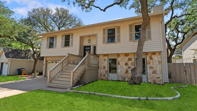 bi-level home featuring a front yard and a garage