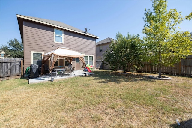 rear view of property with a yard and a patio