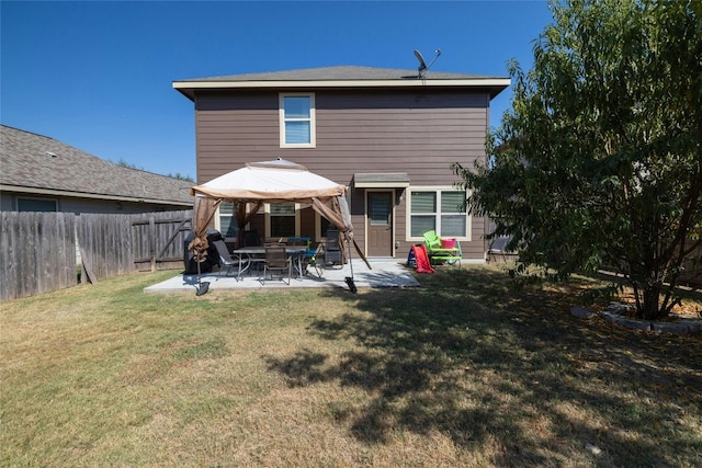 back of house with a patio area and a lawn