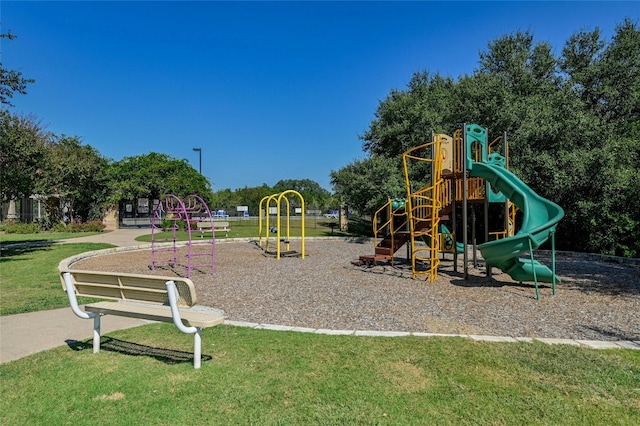 view of playground with a lawn