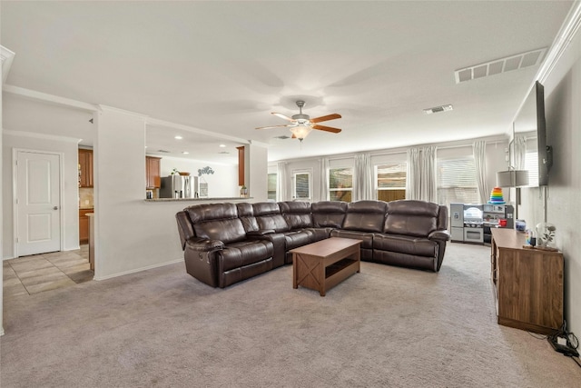 living room featuring crown molding, light colored carpet, and ceiling fan