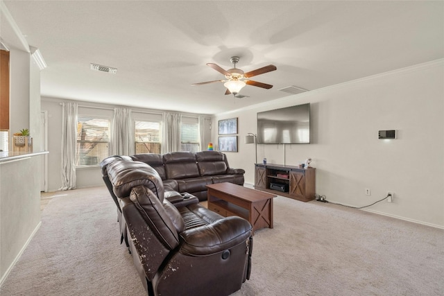 carpeted living room featuring crown molding and ceiling fan