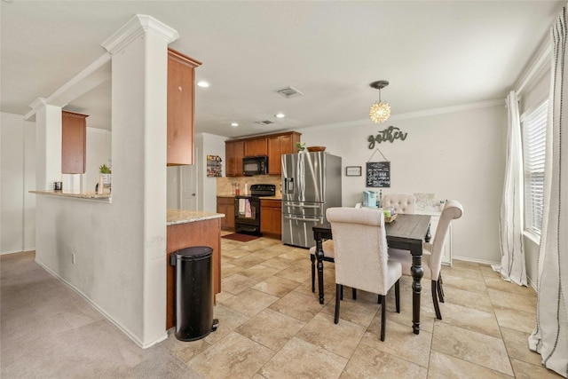 dining room featuring crown molding and decorative columns