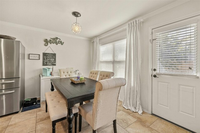 dining room with crown molding and a healthy amount of sunlight