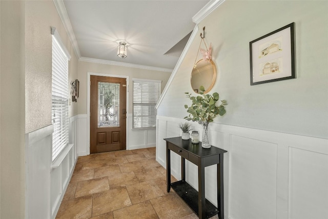 104 Bufflehead Ln, Leander, TX 78641 - entryway featuring stone finish flooring, a decorative wall, a wainscoted wall, and ornamental molding
