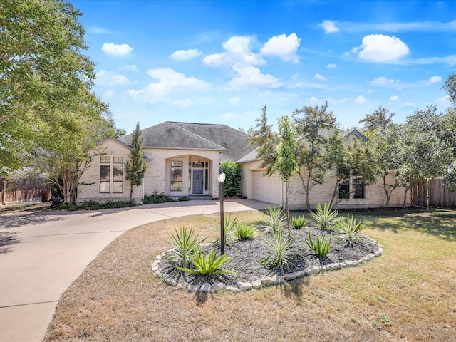 view of front of home with a front yard and a garage