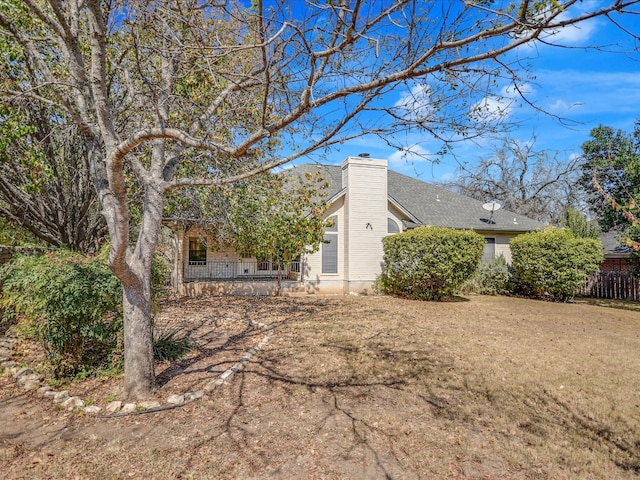 back of property featuring a lawn