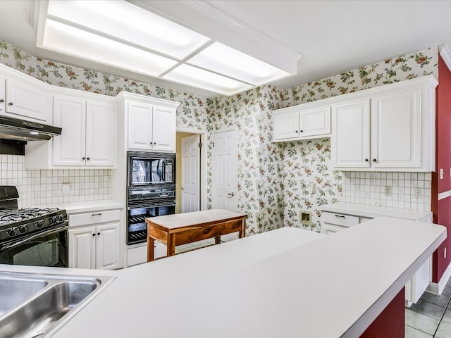 kitchen with white cabinets, tasteful backsplash, black appliances, and light tile patterned floors