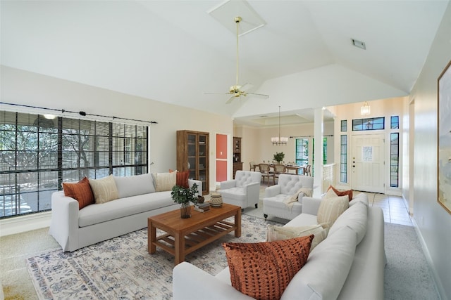 living room with lofted ceiling, a healthy amount of sunlight, and light colored carpet