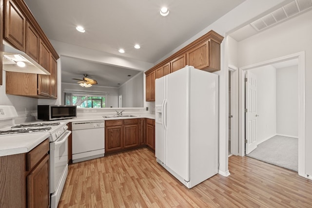 kitchen with white appliances, light hardwood / wood-style flooring, ceiling fan, and sink