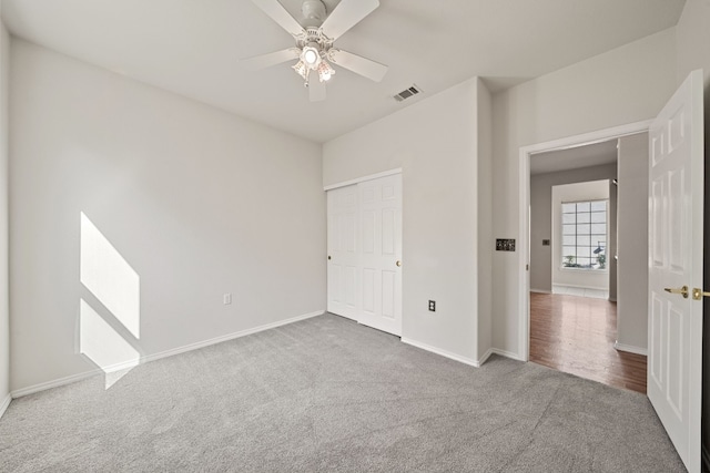 unfurnished bedroom featuring carpet and ceiling fan