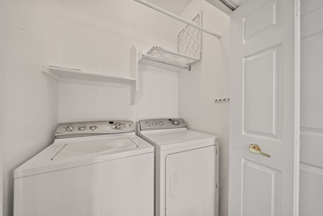 laundry area with washing machine and clothes dryer