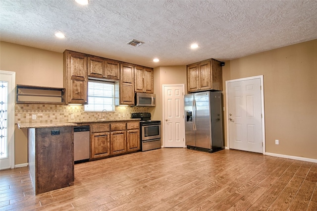 kitchen featuring sink, hardwood / wood-style floors, and appliances with stainless steel finishes