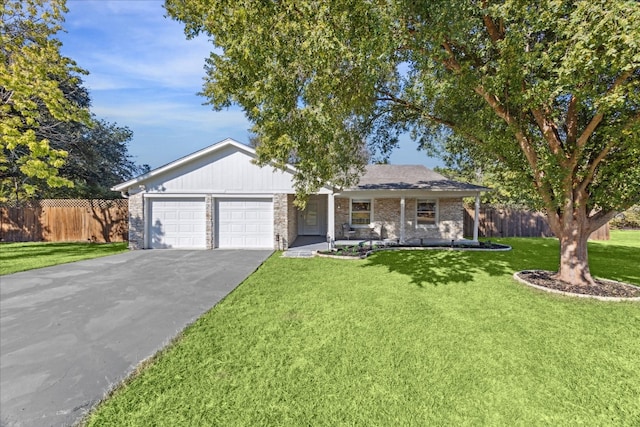 ranch-style home featuring a front lawn and a garage