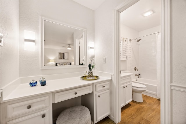 full bathroom with vanity, hardwood / wood-style flooring, shower / tub combination, and toilet