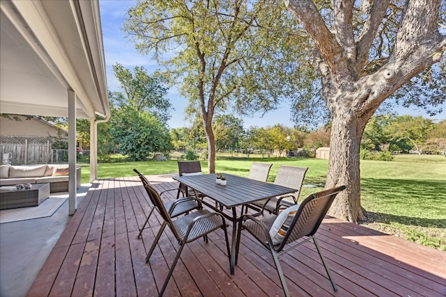 wooden deck featuring a shed, an outdoor hangout area, and a lawn