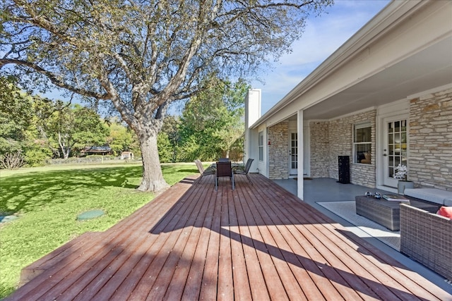 wooden deck with outdoor lounge area and a lawn