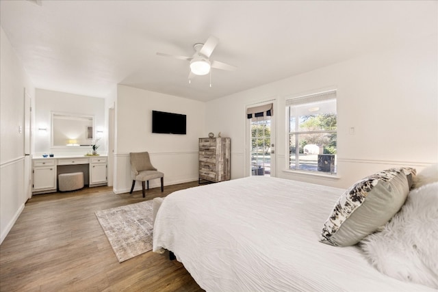 bedroom featuring ceiling fan, access to outside, ensuite bathroom, and light wood-type flooring