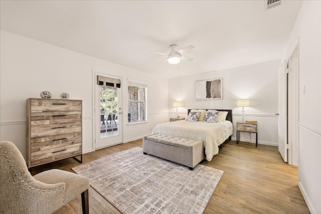 bedroom featuring hardwood / wood-style flooring, ceiling fan, and access to outside