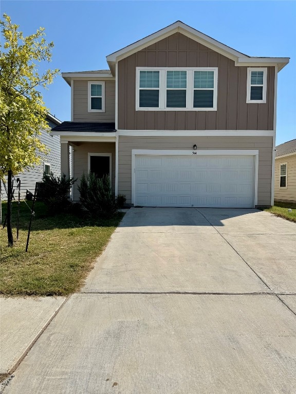 view of front of house featuring a garage and a front lawn