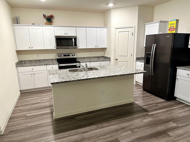 kitchen with a kitchen island with sink, white cabinets, and appliances with stainless steel finishes