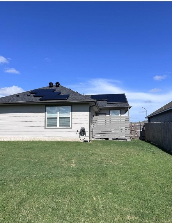 back of house featuring a yard