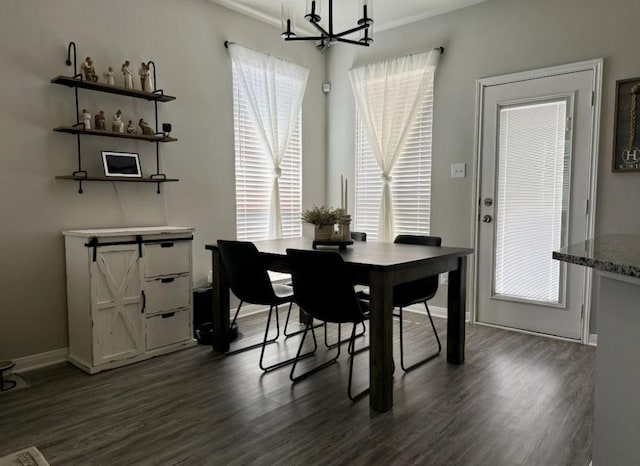 dining area featuring a barn door and dark hardwood / wood-style flooring