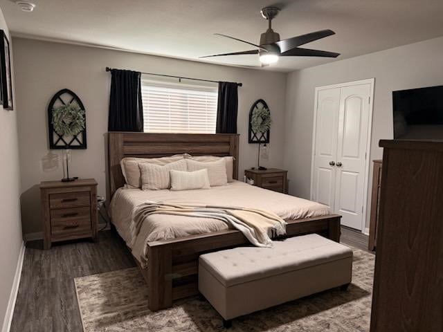 bedroom with dark hardwood / wood-style flooring, a closet, and ceiling fan