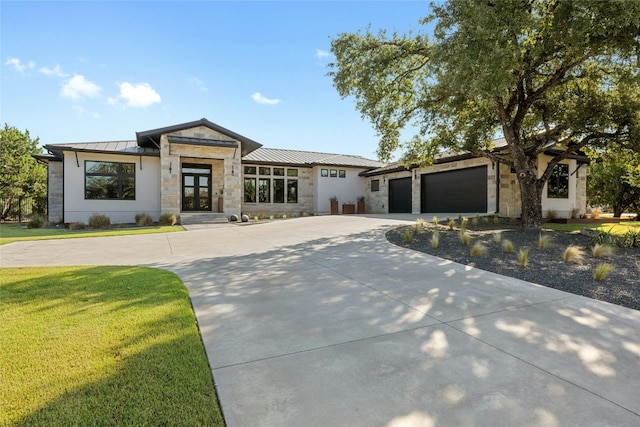 view of front of house with a front yard and a garage