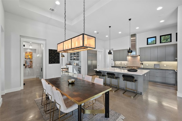 dining area with sink and a tray ceiling