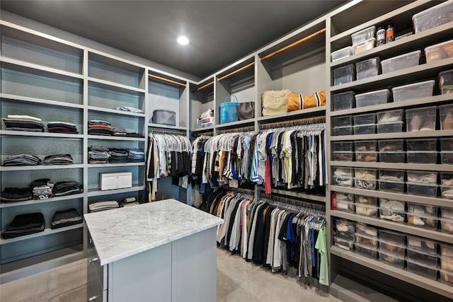 walk in closet with light colored carpet