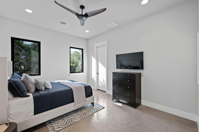 bedroom with ceiling fan and concrete flooring