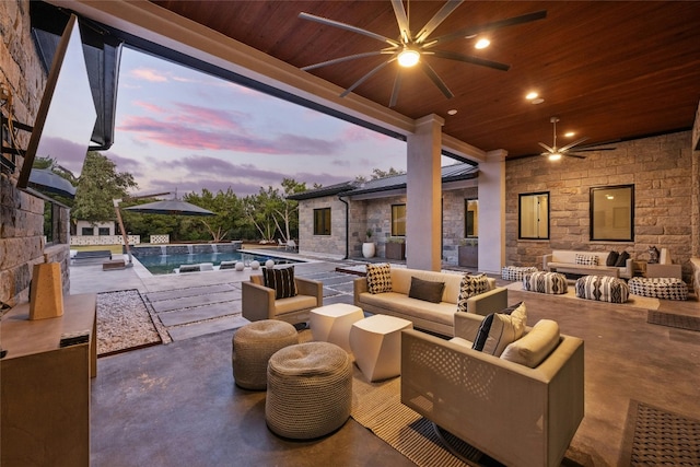 patio terrace at dusk with an outdoor living space, pool water feature, and ceiling fan