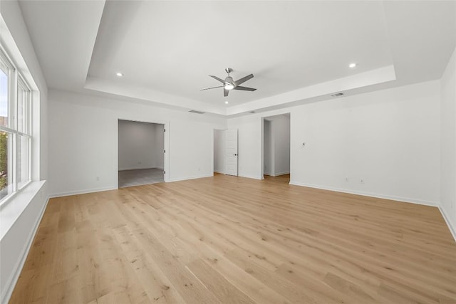 2305 Shane Ranch Dr, Cedar Park, TX 78641 - spare room featuring a tray ceiling, a ceiling fan, light wood finished floors, and recessed lighting
